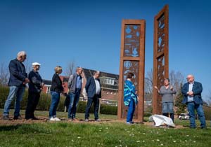 Wethouder Theo Jansen (rechts) onthult samen met Irene Loeff (streepjesshirt) en Mieke Bles (blauw) het kunstwerk Forës op Loovelden.  Erik van 't Hullenaar